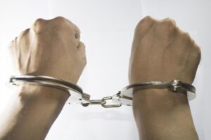 of-both-hands-in-police-steel-handcuffs-cool-shiny-white-free-photo